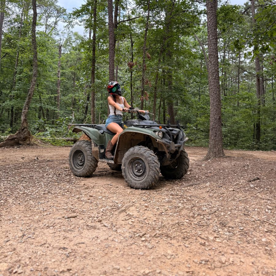 Riding an ATV on the forest trails at Wolf Pen Gap, minutes from Arborium Cabins