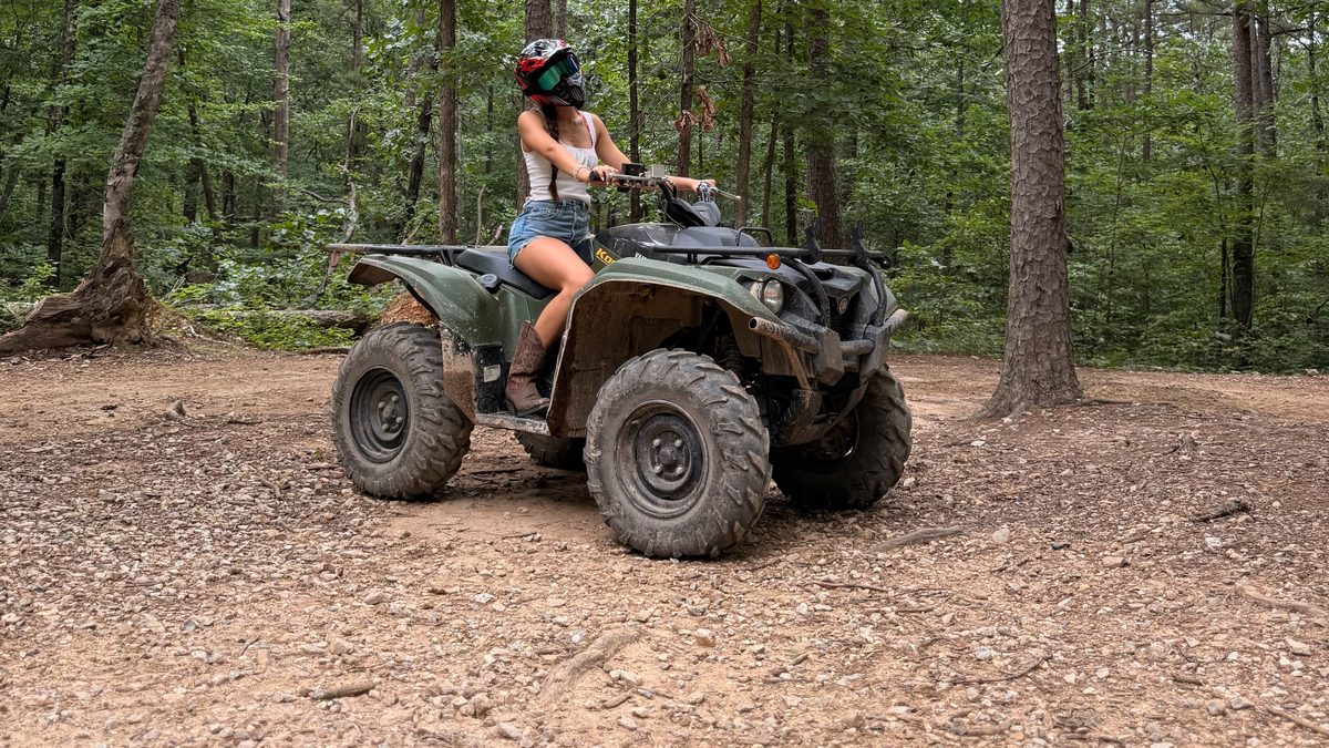 Riding an ATV on the forest trails at Wolf Pen Gap, minutes from Arborium Cabins