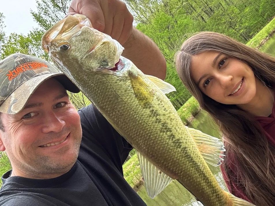 Simão and Lara with a largemouth bass caught in the stocked pond at Arborium