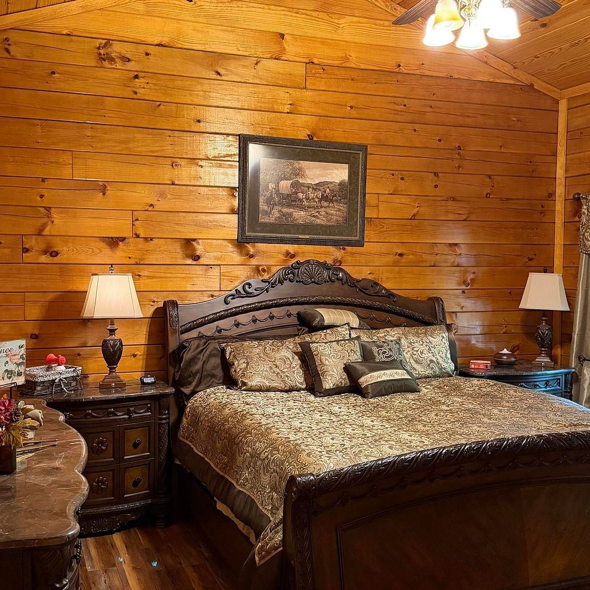 Second bedroom with sleigh bed, marble-top nightstands and log walls