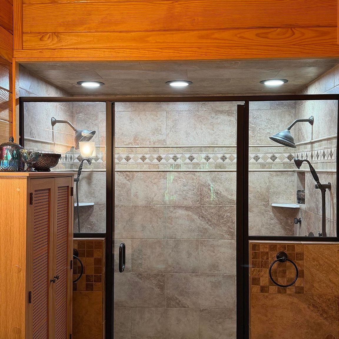 Walk-in tile shower with glass door and dual shower heads
