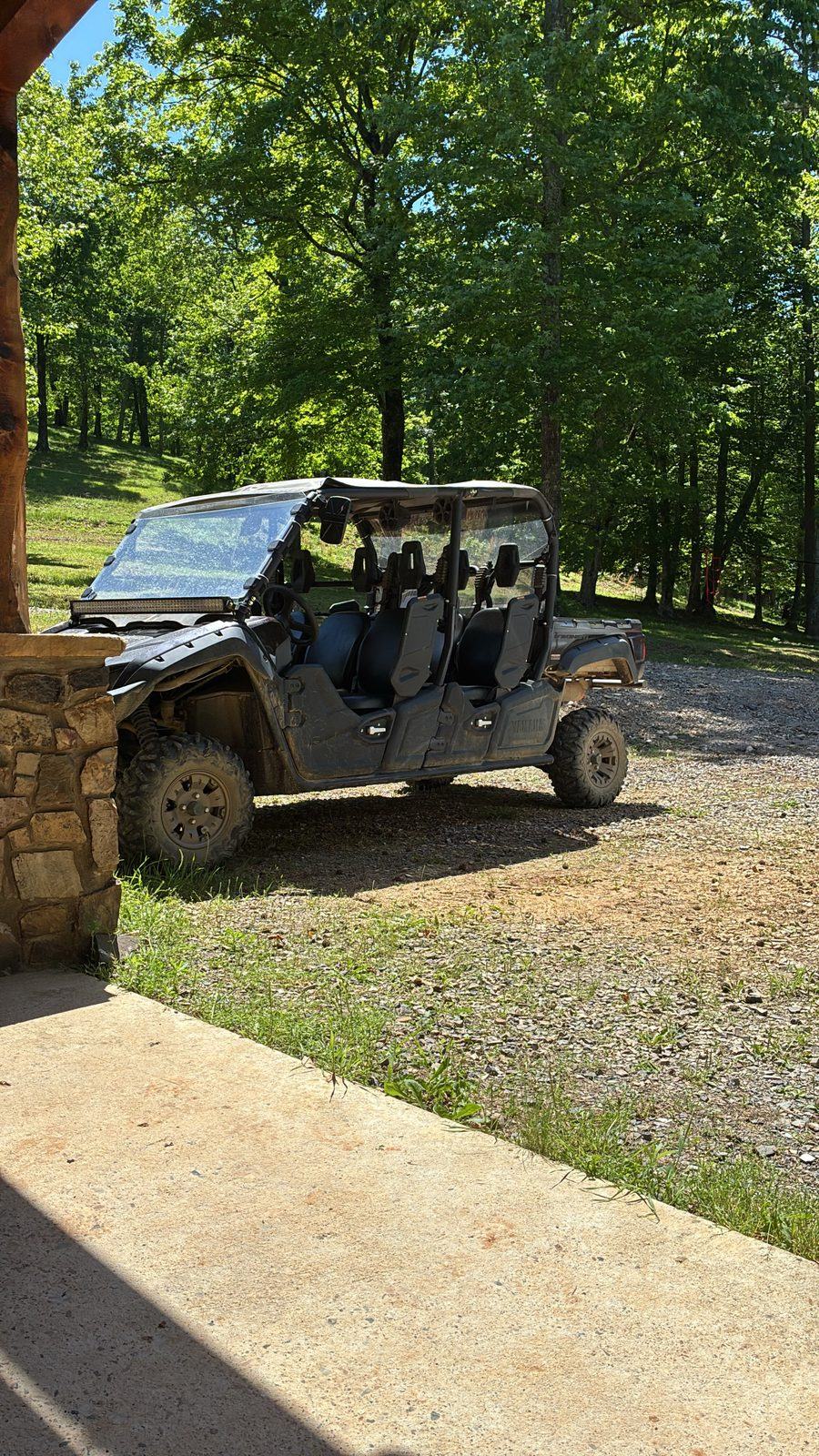 The six-seat Yamaha Viking VI parked by the cabin porch, ready for the trails